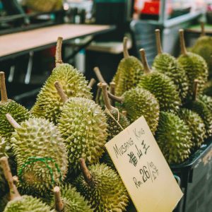 A vibrant display of Musang King durians for sale at a market in Kuala Lumpur.