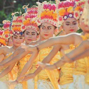Colorful Balinese dancers performing a traditional ceremony in Indonesia.